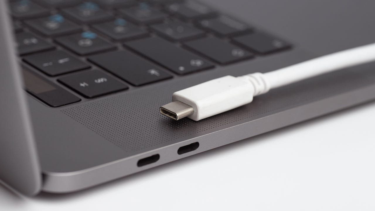 Two Thunderbolt 3/USB4 ports nestled between a HagSafe port and 3.5mm headphone jack on a MacBook Pro