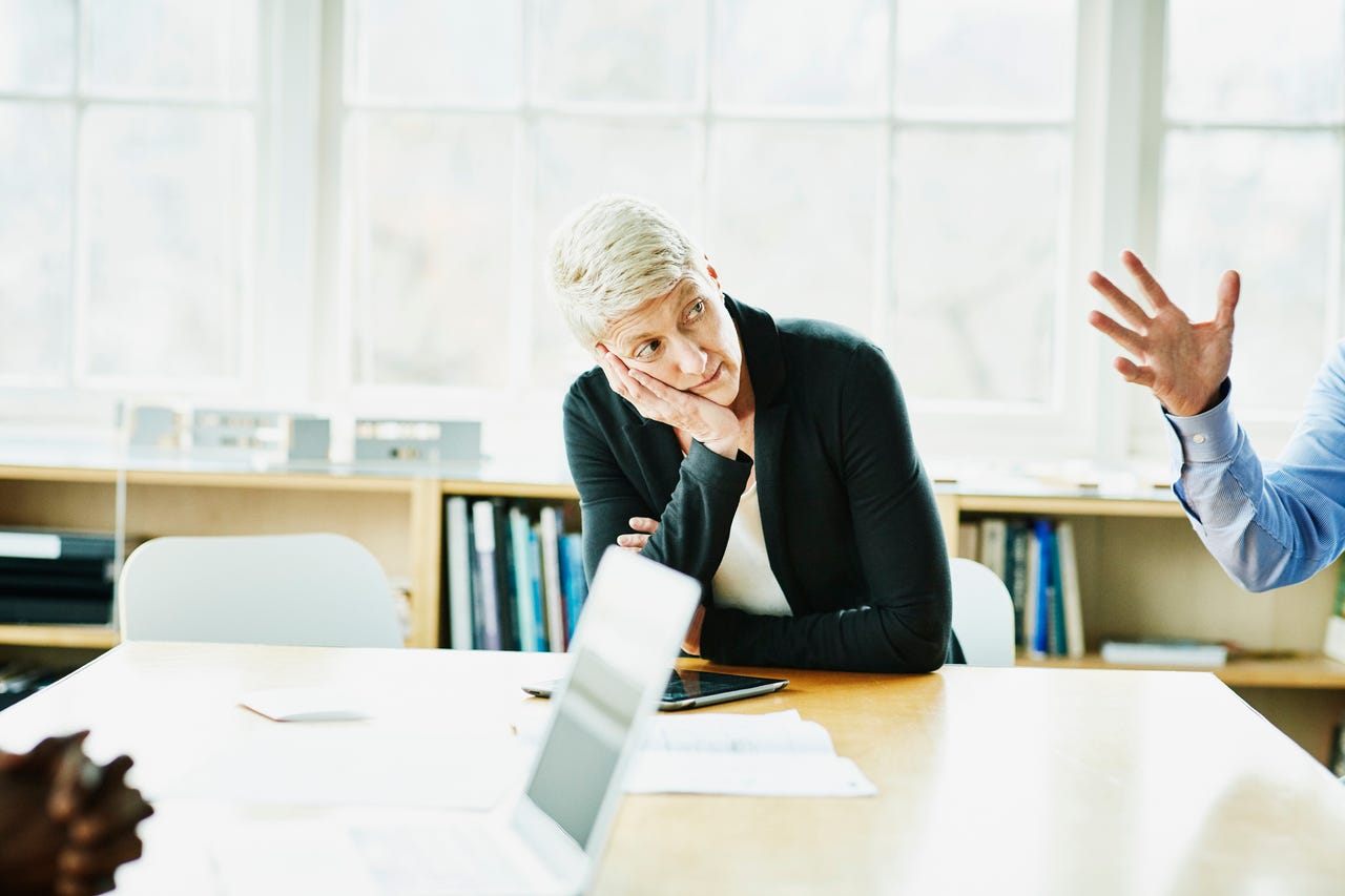 a woman looking bored in a meeting