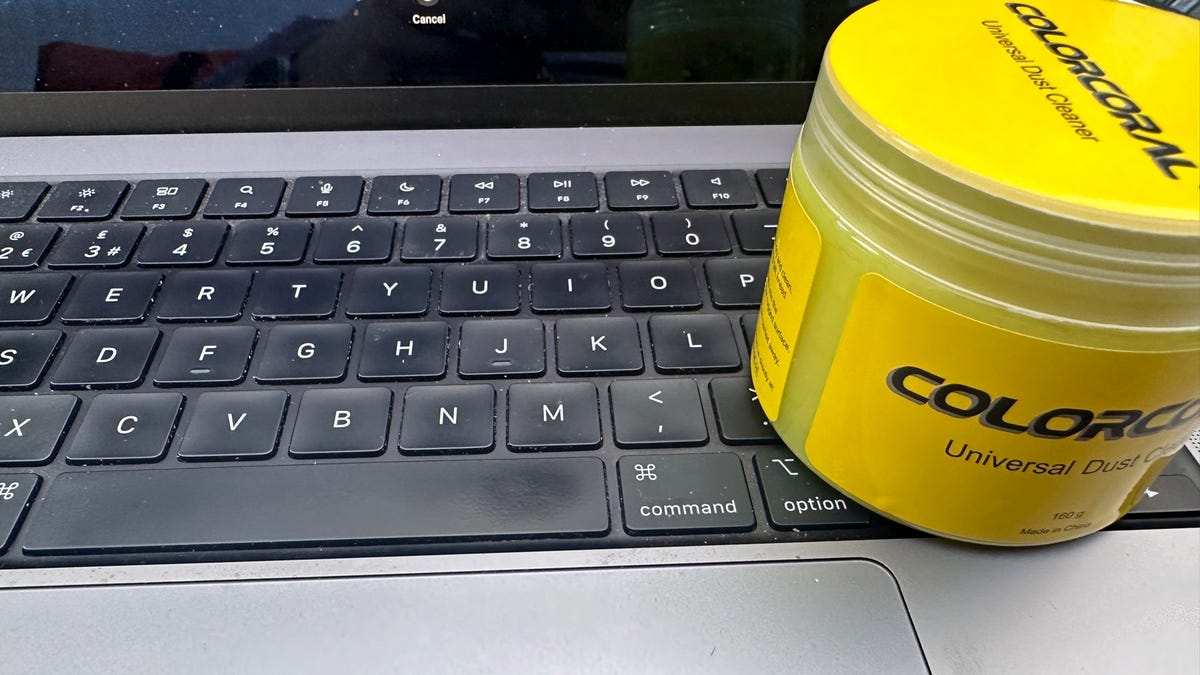 Bottle of ColorCoral cleaning gel on laptop.