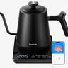 Black tea kettle with a smartphone next to it