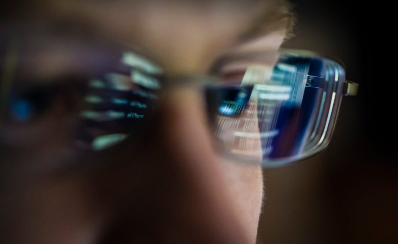 gettyimages-portait-of-young-hacker-with-computer-screen-reflecting-in-the-mans-glasses-stock-photo.jpg
