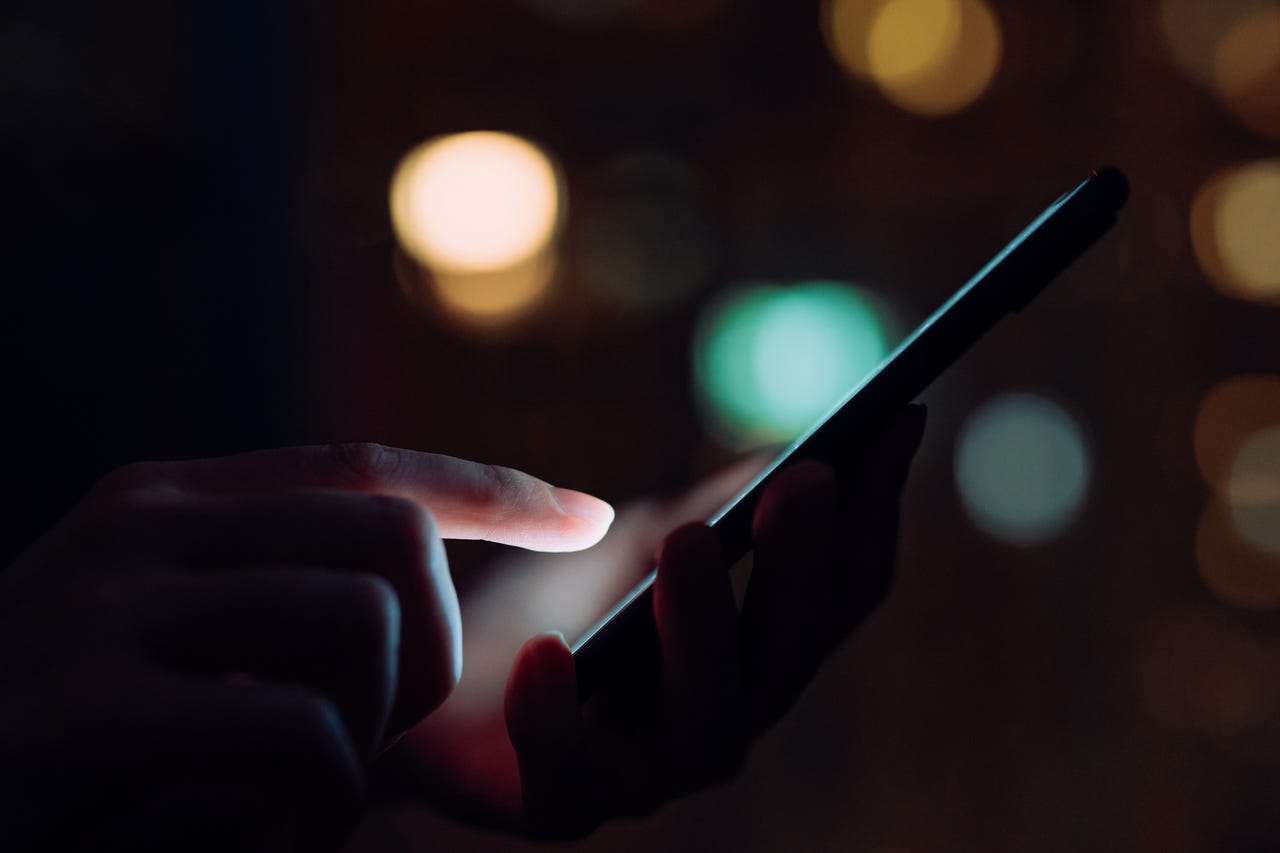 woman using phone in the dark