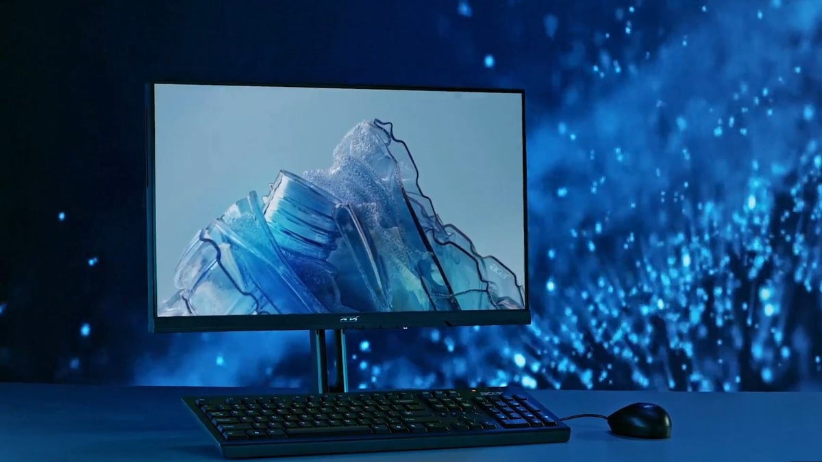 یک Acer Vero همه در یک کامپیوتر در مقابل پس‌زمینه آب پاشیدن