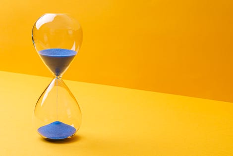 Hourglass against a orange/yellow background