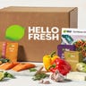 A cardboard box of HelloFresh with fresh produce in front of it