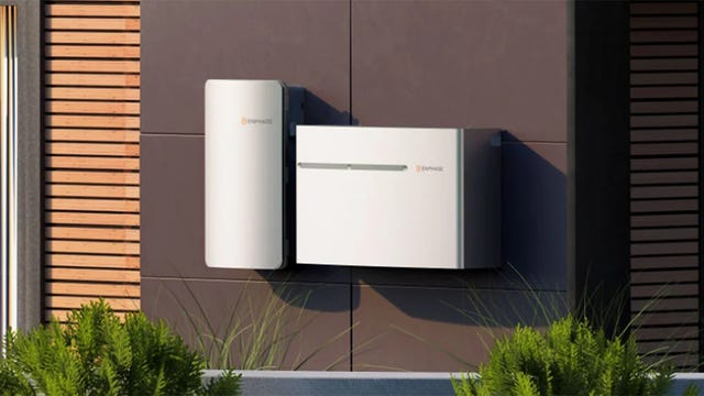 An Enphase IQ system mounted on a dark, exterior wall