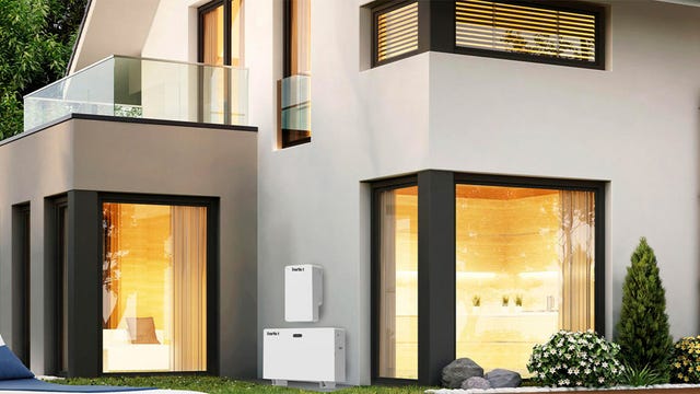 A Panasonic Evervolt system installed on the exterior of a white, minimalist home
