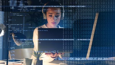 woman looking at code on a computer