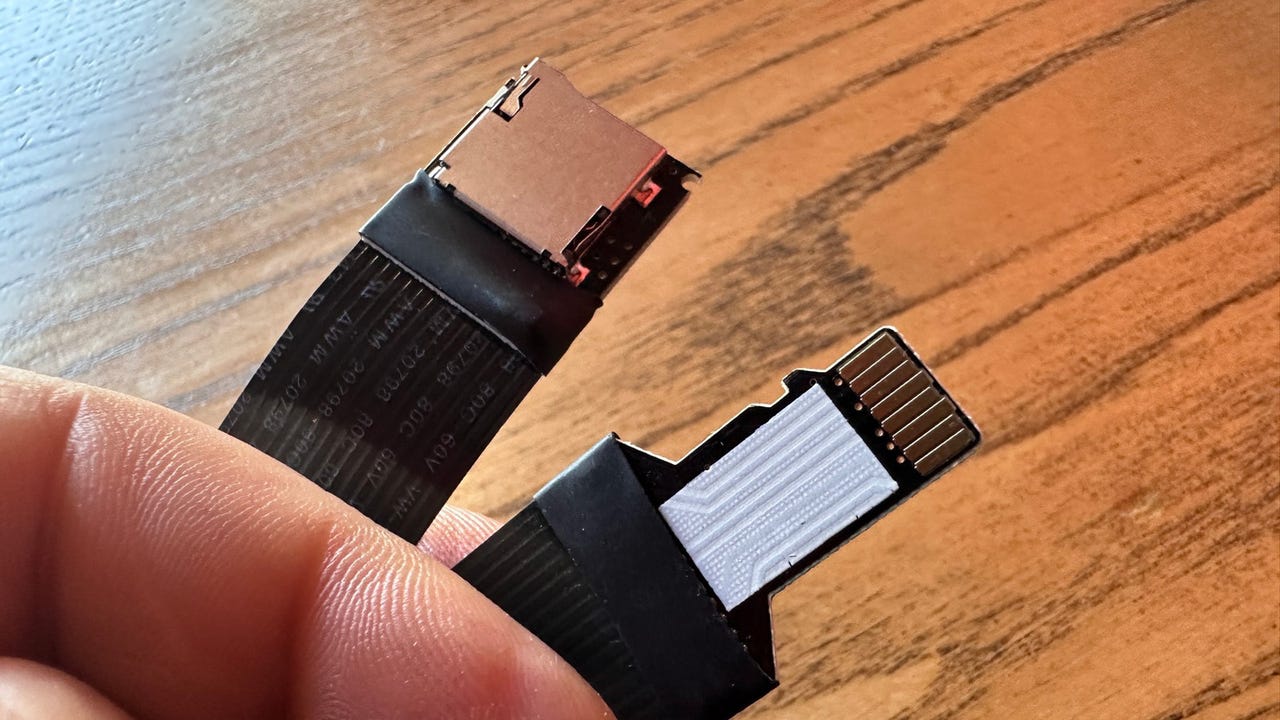 Hand holding microSD extension cable for the Raspberry Pi