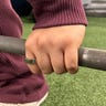 Oura Ring 3 on a hand grabbing a barbell