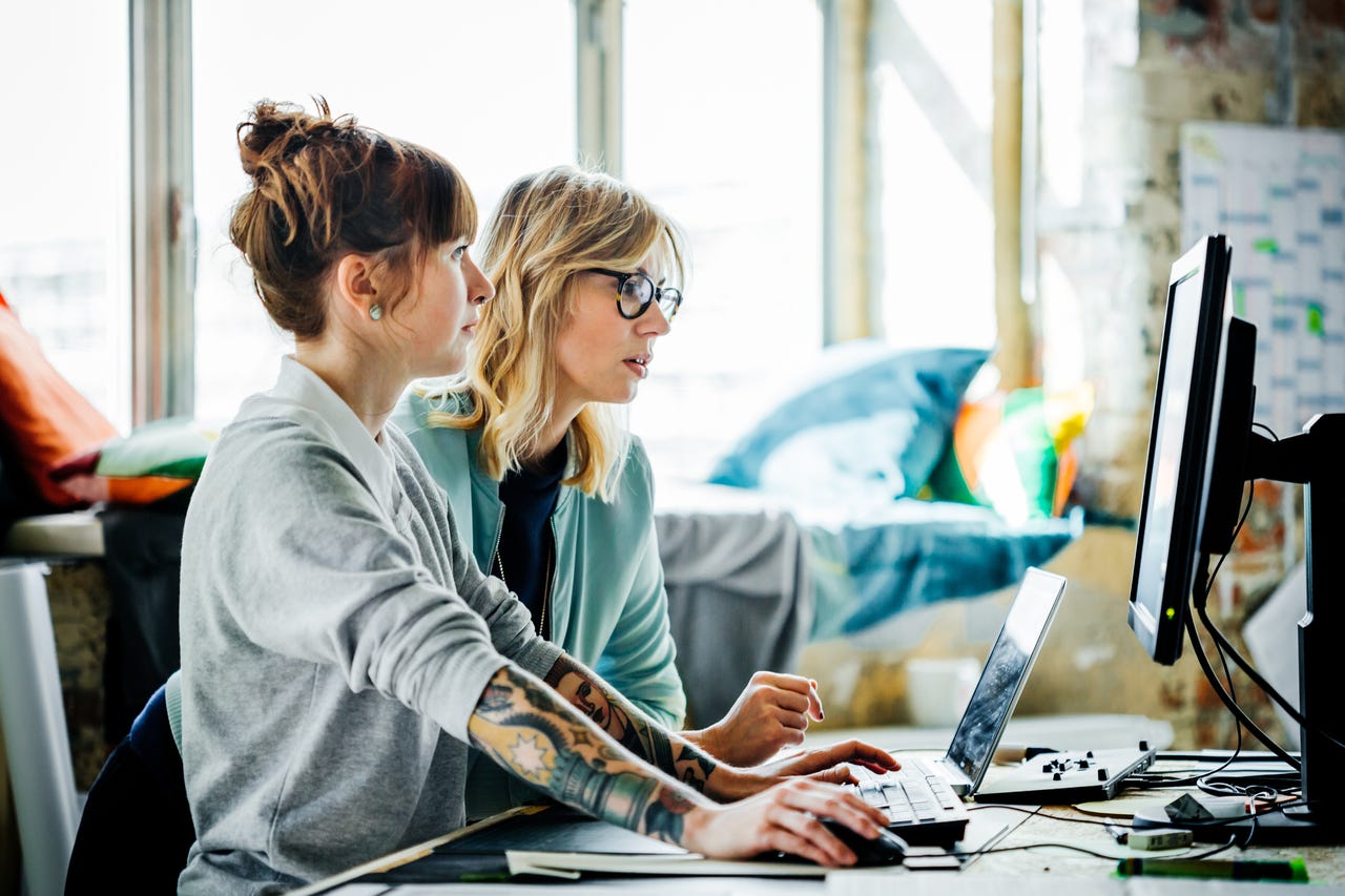 Two women working on computer