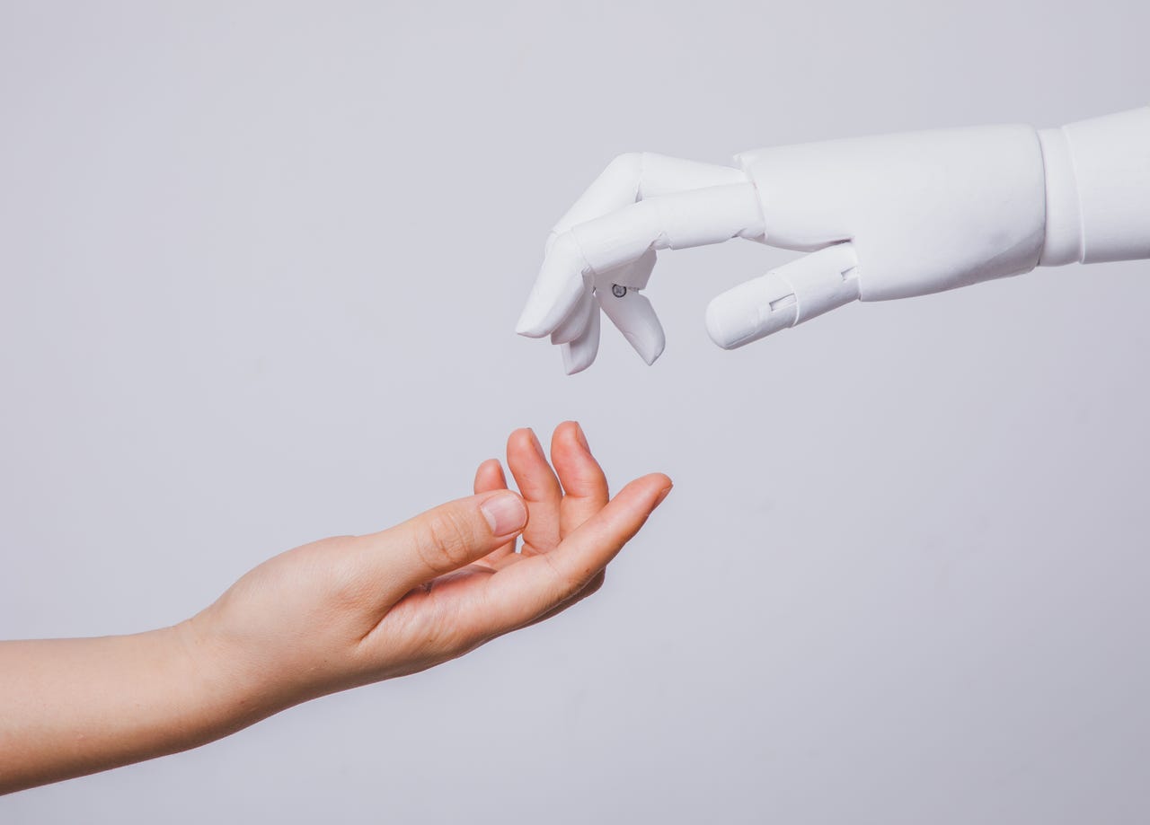 Robot hand reaching out for a human hand