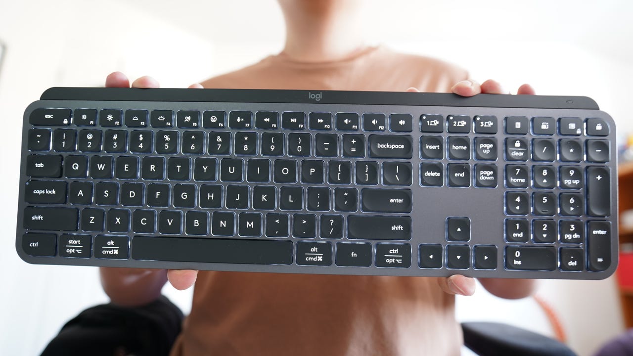 Person holding up the Logitech MX Keys S in Graphite