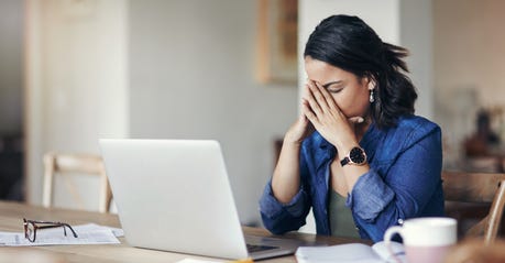 frustrated woman in front of a computer
