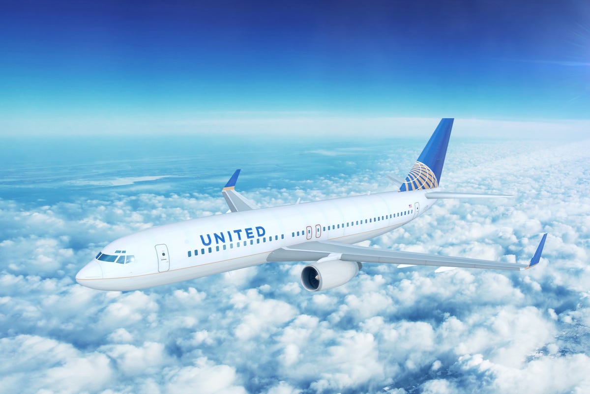 United Airlines airplane above the clouds in the sky