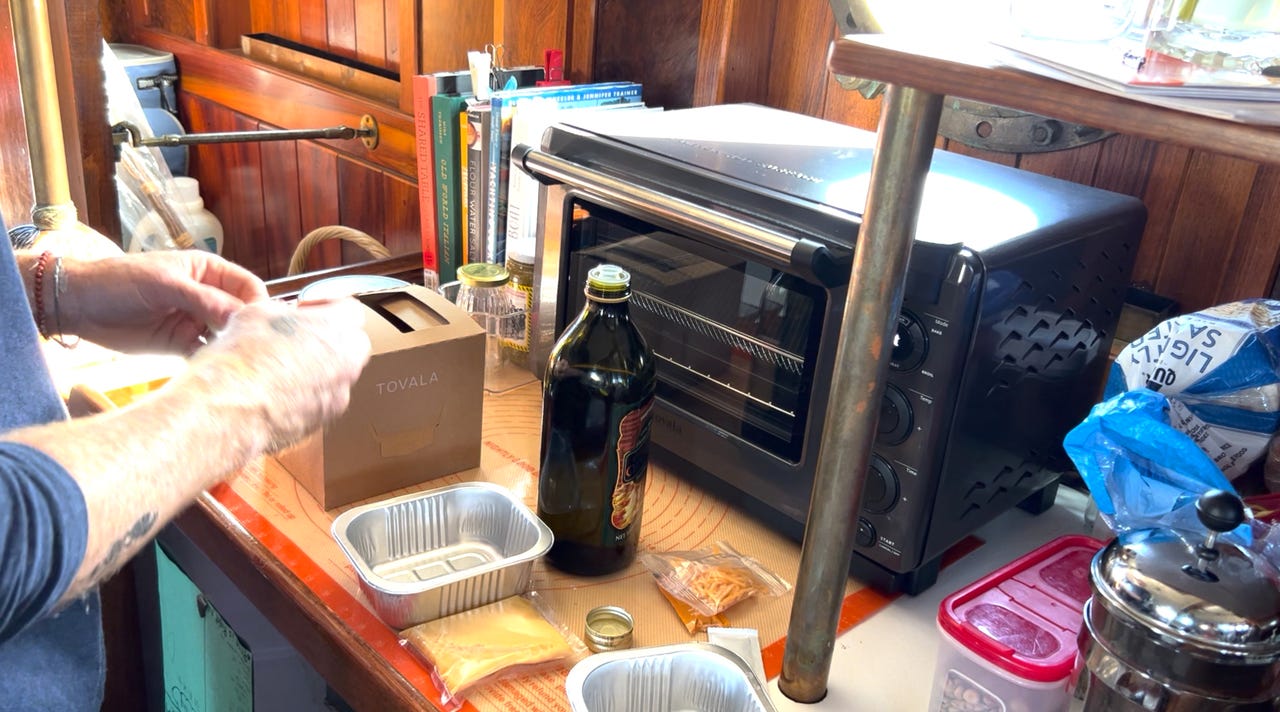 Oiling a small baking dish in front of the Tovala Smart Oven